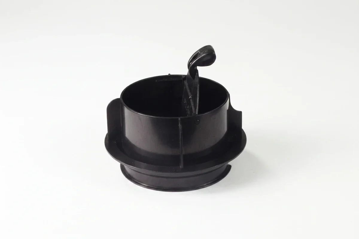 Black cylindrical plastic device with an open top and raised hinged lever against a white background.